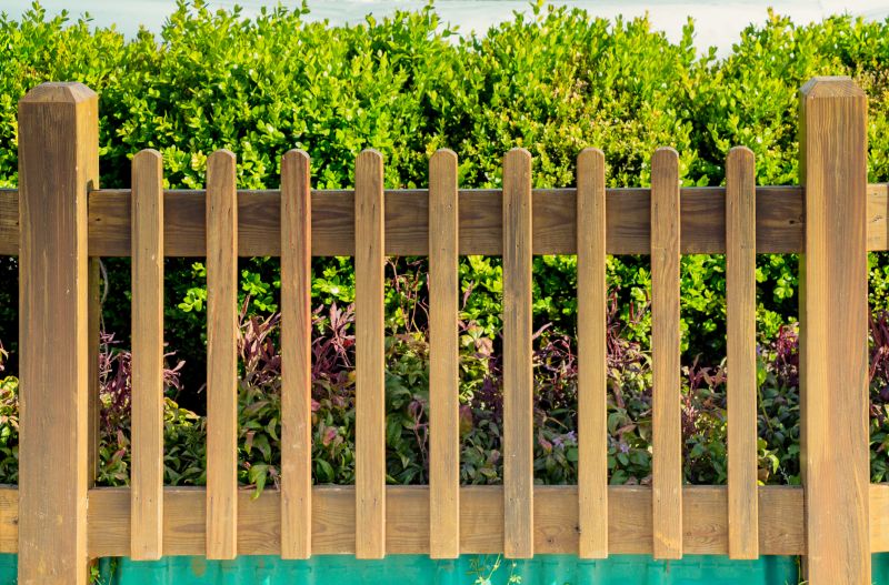Stained Picket Fence in a Garden